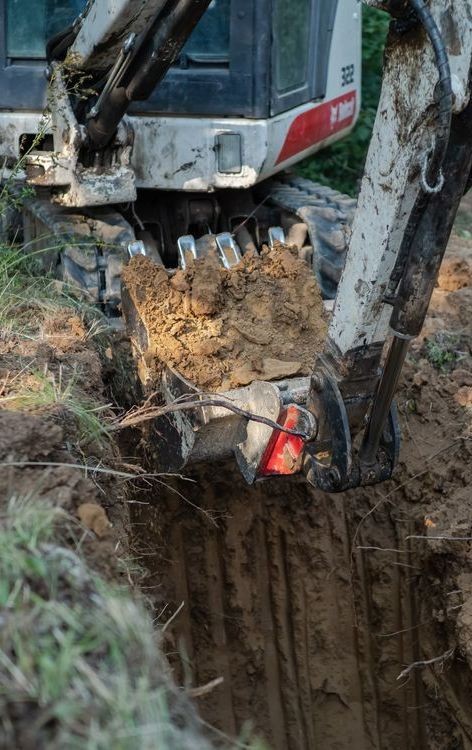 A Bulldozer is Digging a Hole in the Dirt — Copp & Co Civil & Plant Hire in Cannonvale, QLD