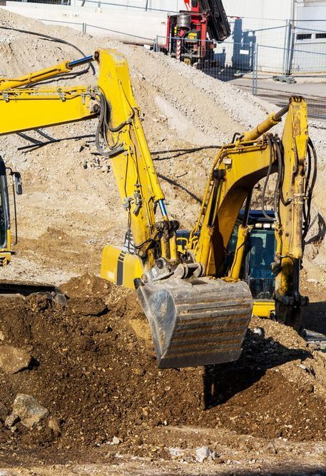 Two Yellow Excavators Are Working on a Construction Site — Copp & Co Civil & Plant Hire in Proserpine, QLD