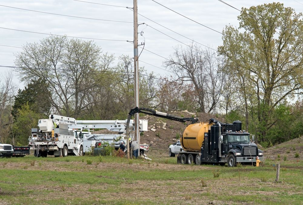 A Vacuum Truck is Pumping Water Into a Field — Copp & Co Civil & Plant Hire in Cannonvale, QLD