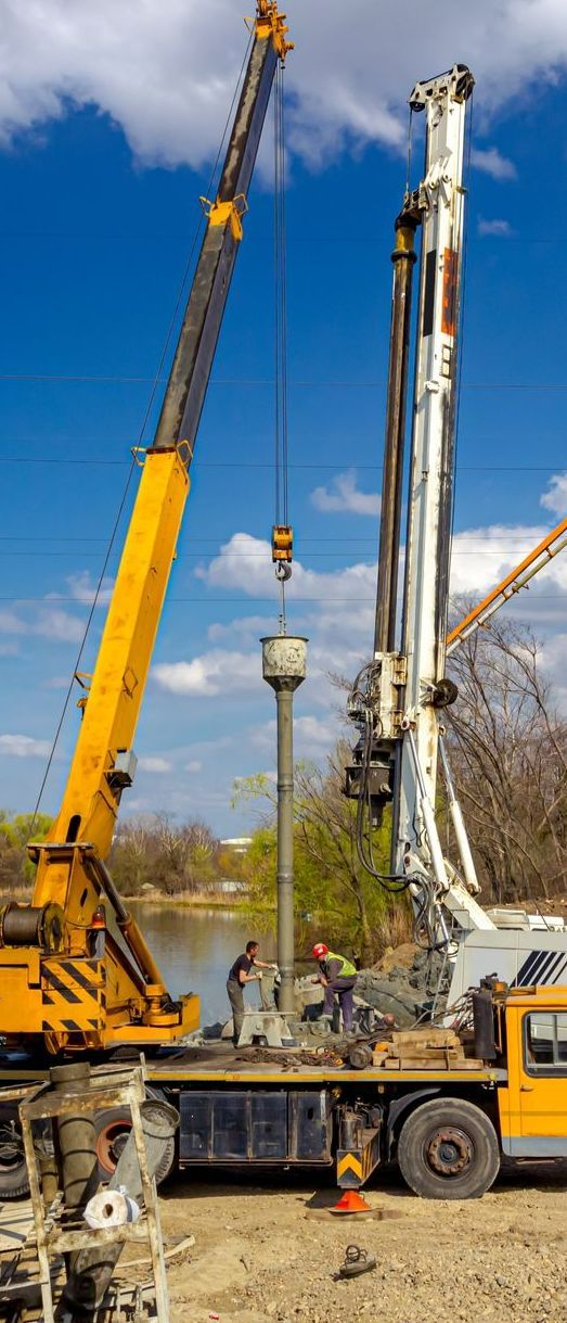 A Crane is Lifting a Pole From a Truck on a Construction Site — Copp & Co Civil & Plant Hire in Cannonvale, QLD