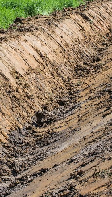 A Dirt Road is Being Built in a Field — Copp & Co Civil & Plant Hire in Proserpine, QLD