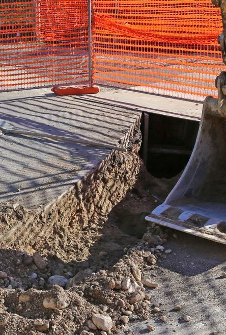 A Bulldozer is Digging a Hole in the Ground at a Construction Site — Copp & Co Civil & Plant Hire in Cannonvale, QLD