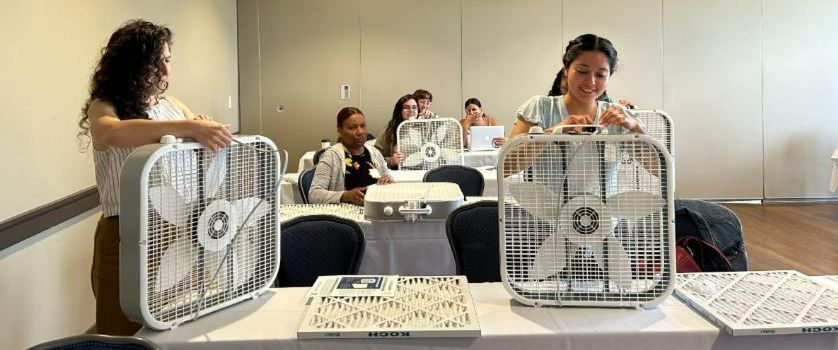 People constructing their own air filters using box fan, filter, and duct tape