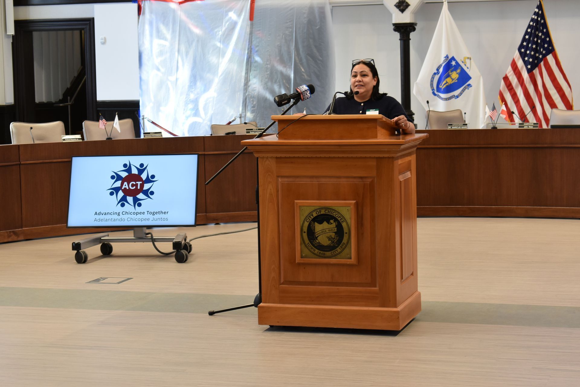 Luz Lopez speaking at podium