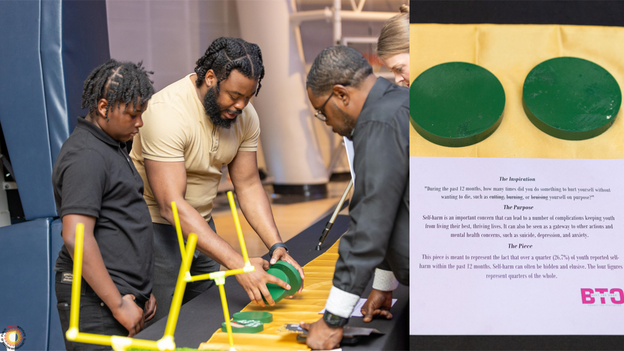 man shows onlookers data visualization made of four green circles of wood