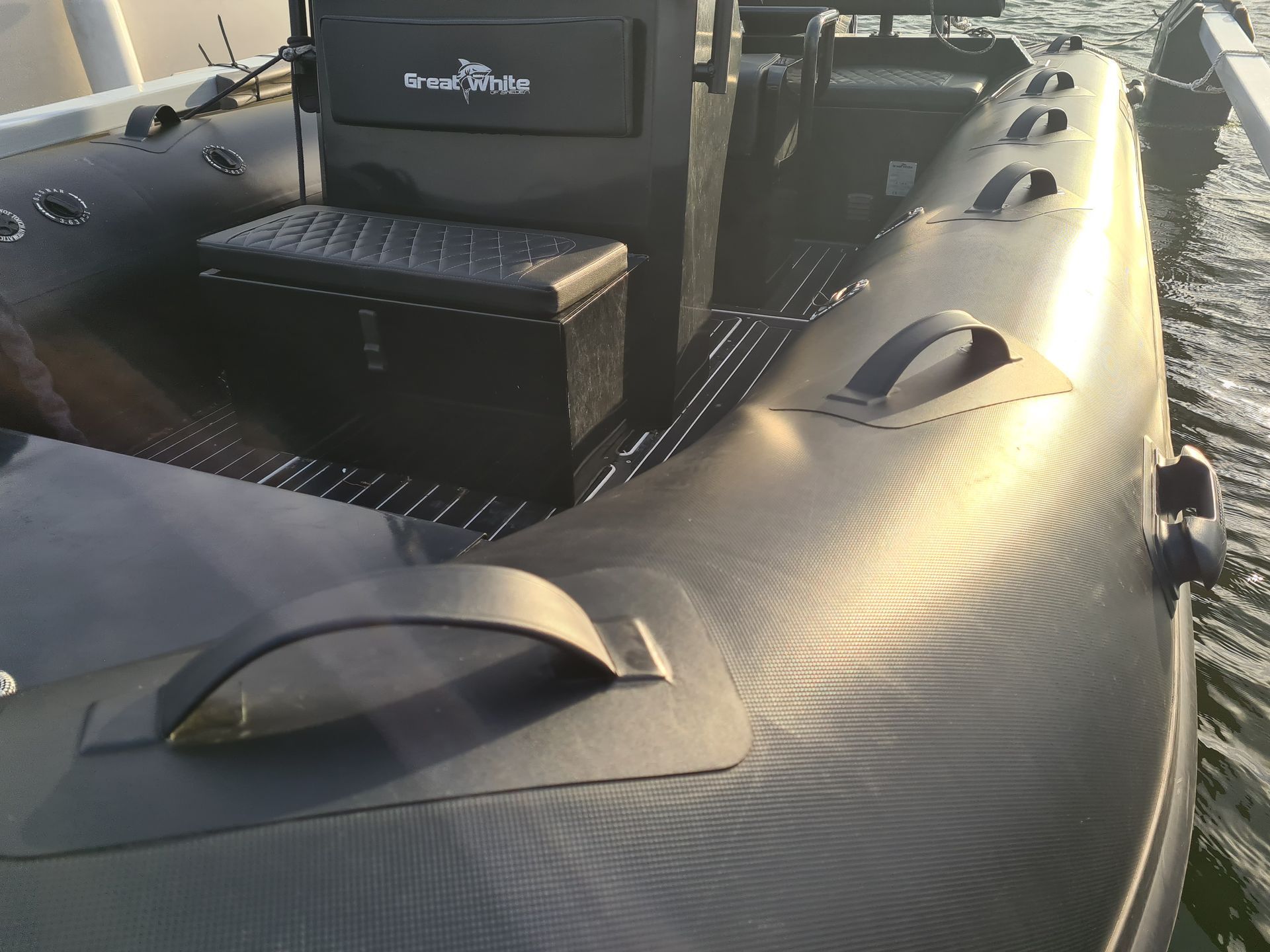 A boat with a box on the back of it is in the water.