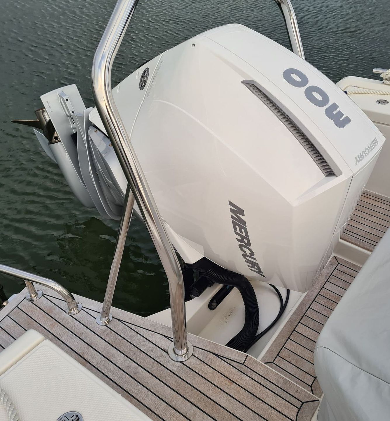 A white mercury outboard motor on a boat