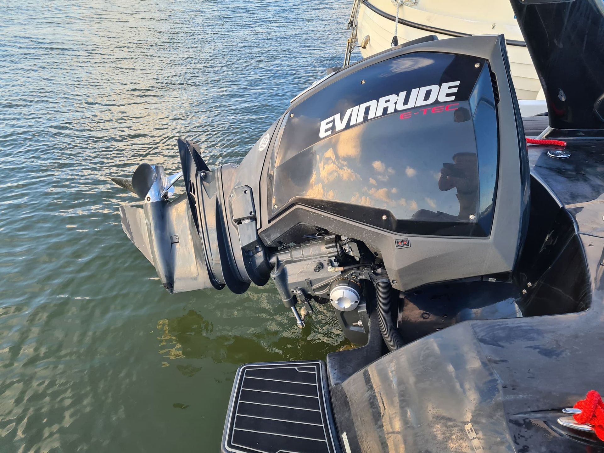 An evinrude outboard motor is sitting in the water