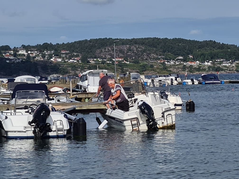 two man trying to move a boat