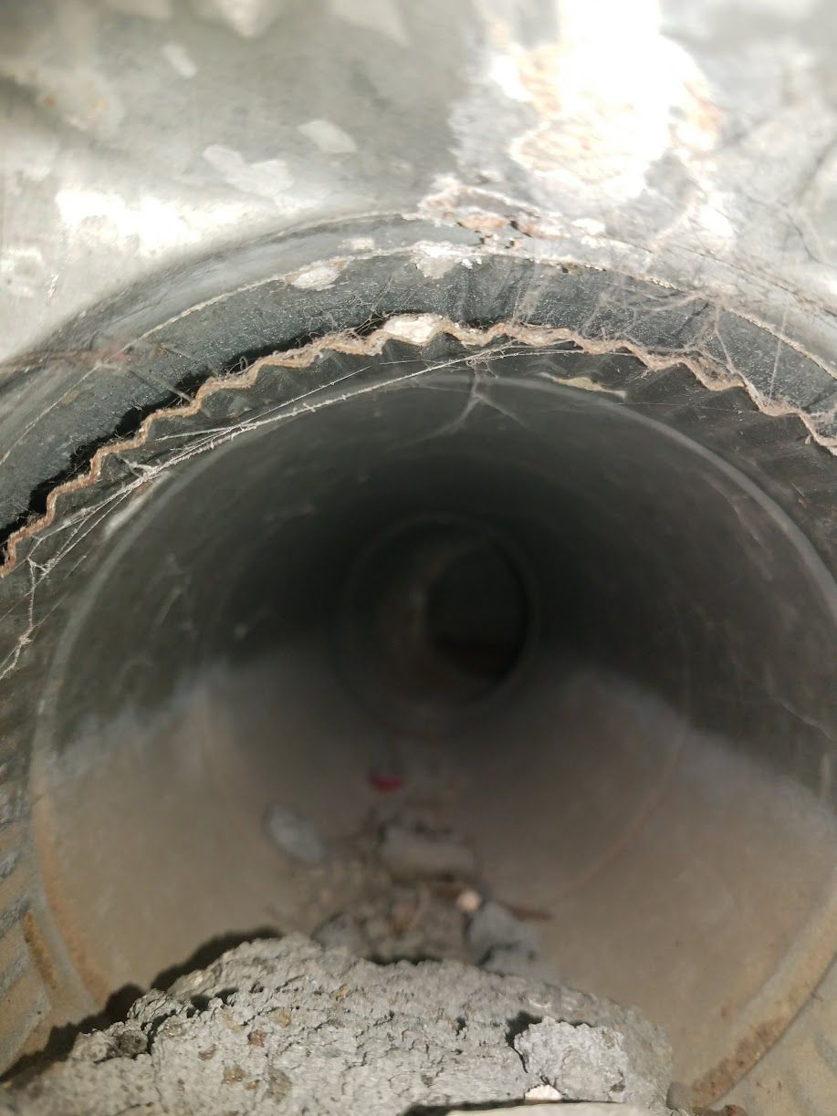 A close up of a metal pipe with a hole in it.