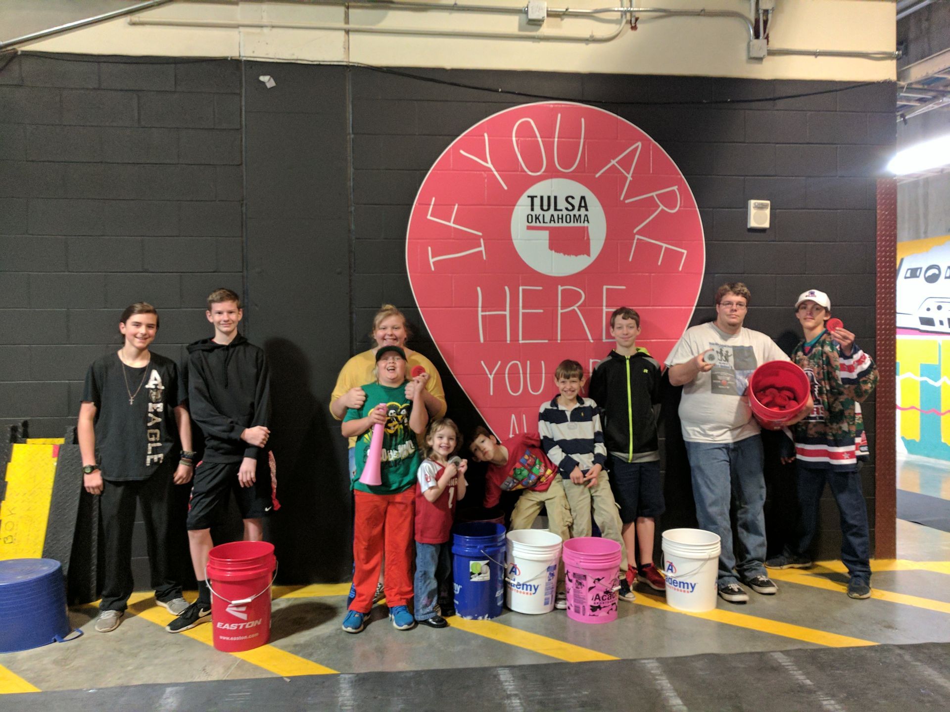 A group of people standing in front of a sign that says you are here