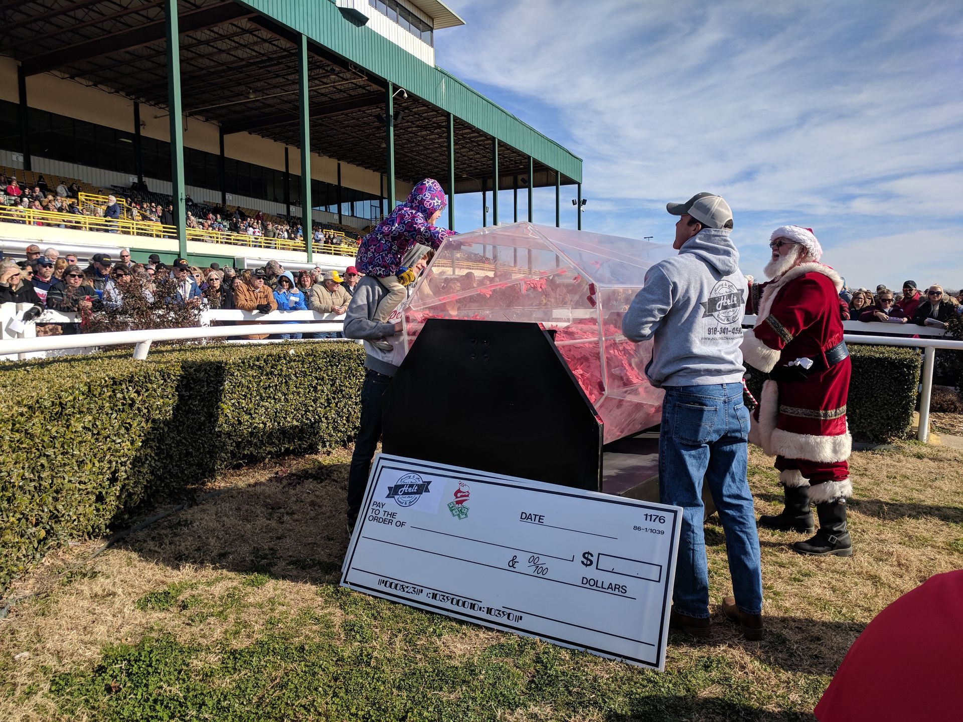 A group of people standing next to a large check.