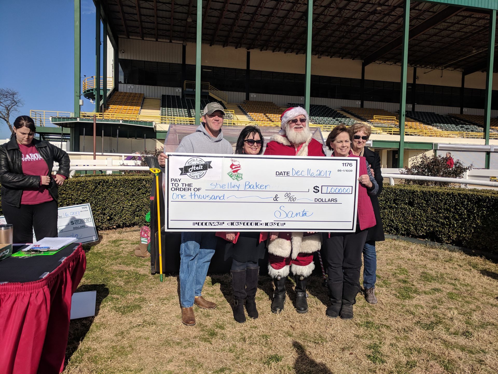A group of people standing next to each other holding a large check.