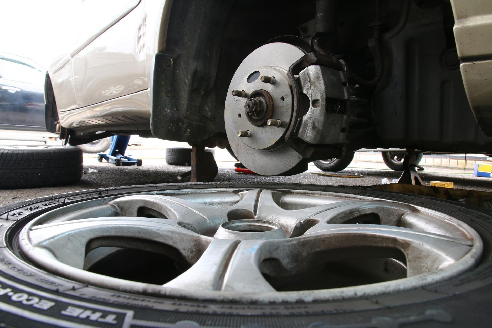 Car with a tire removed, revealing the brake system.