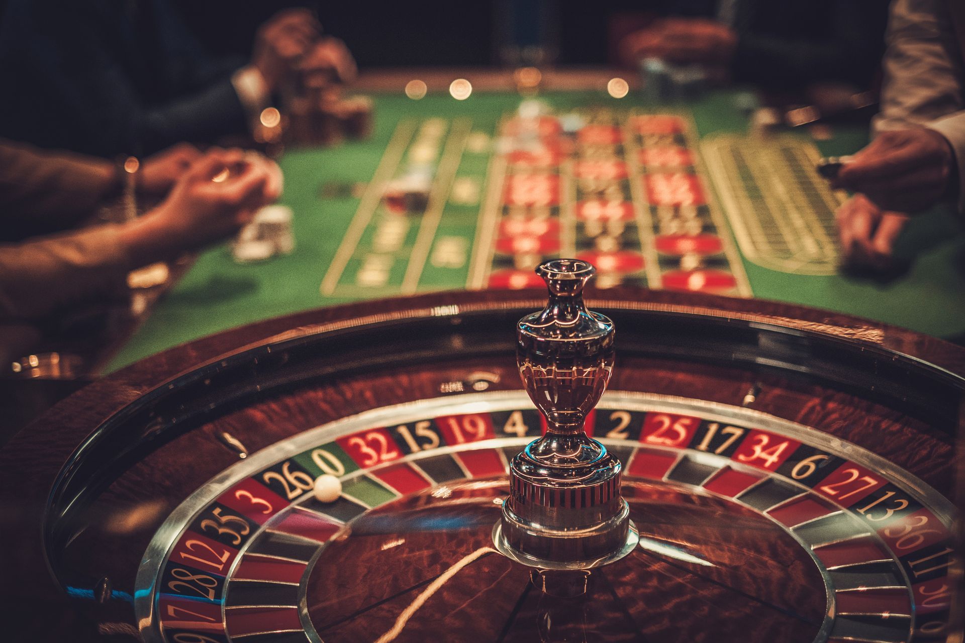 A group of people are playing roulette in a casino.