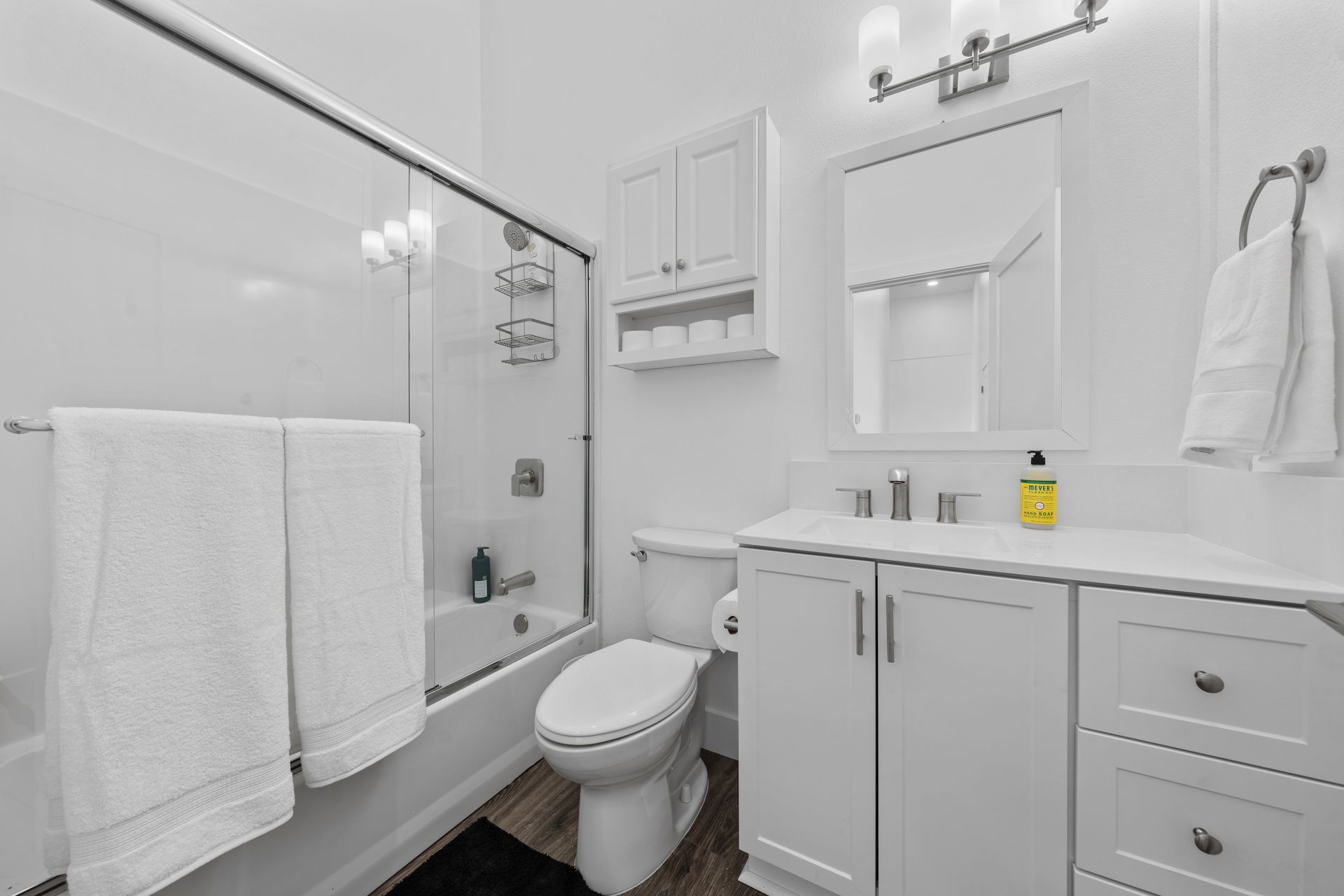 A bathroom with a toilet , sink , bathtub and shower.