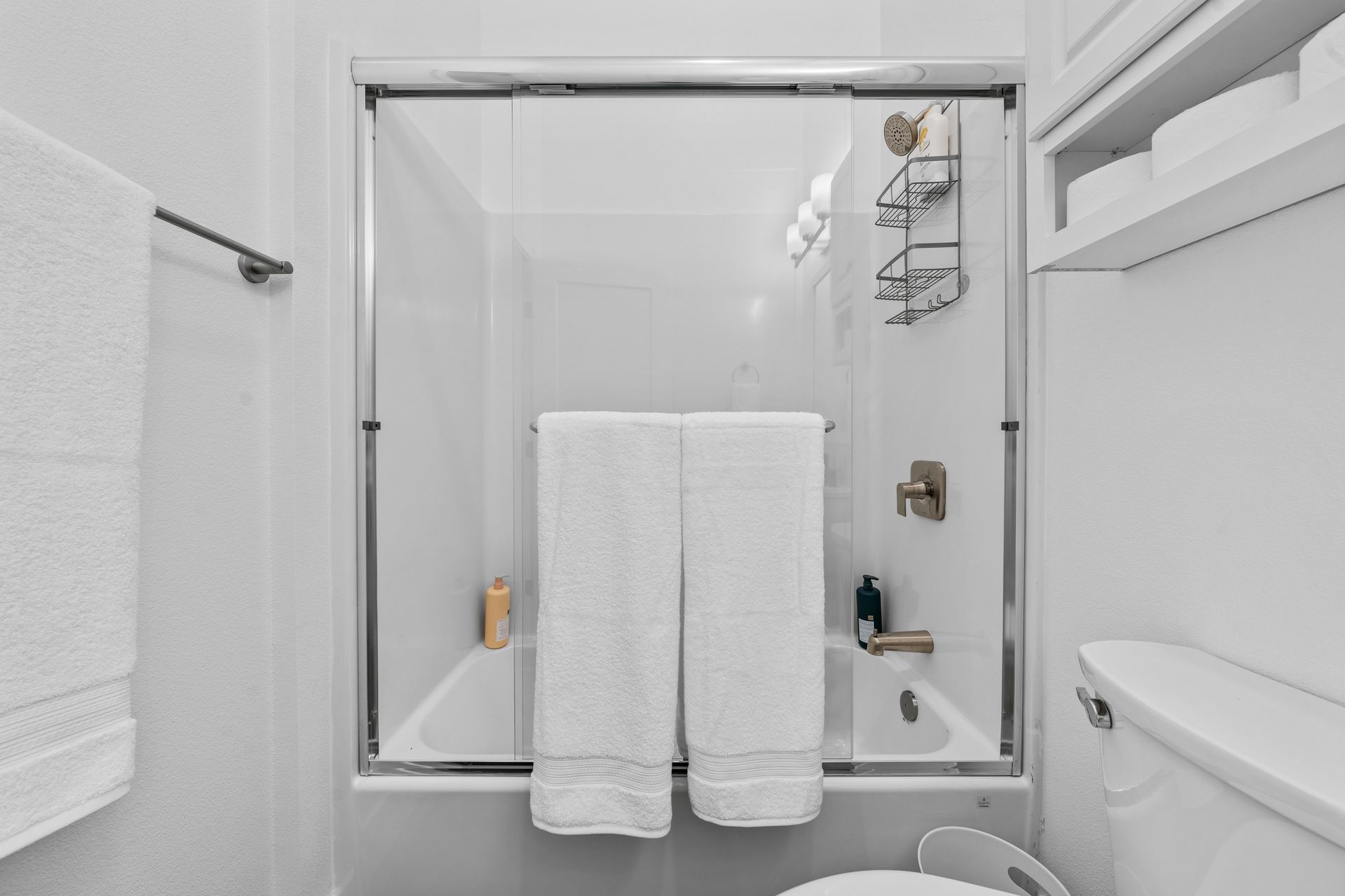 A bathroom with a tub , toilet , and shower.