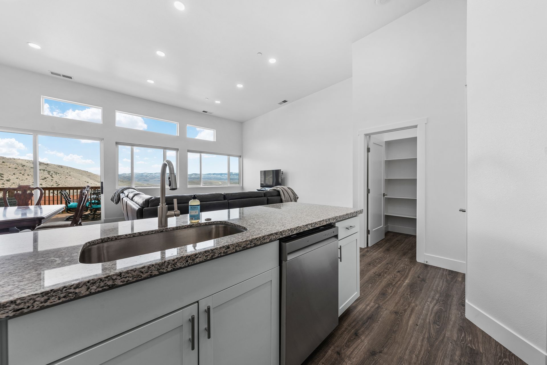 A kitchen with a sink , dishwasher , and stainless steel appliances.