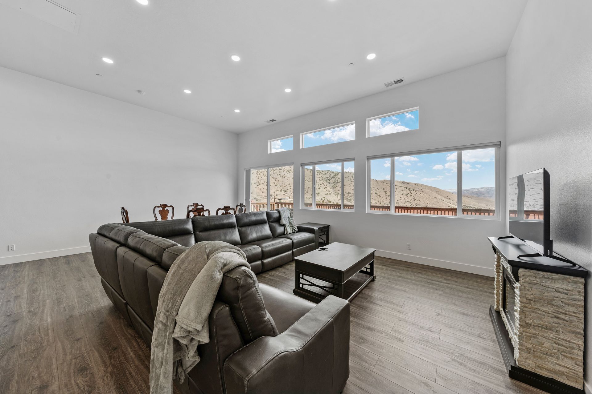 A living room with a couch , coffee table , and television.