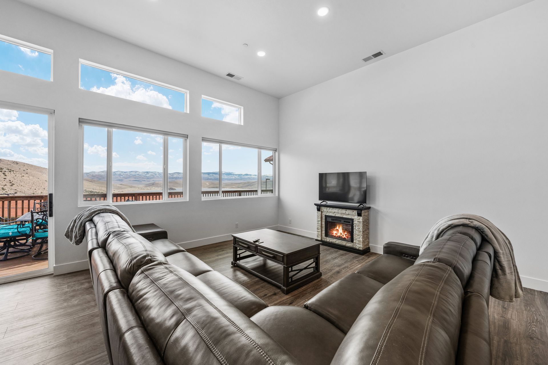 A living room with a couch , fireplace , and television.