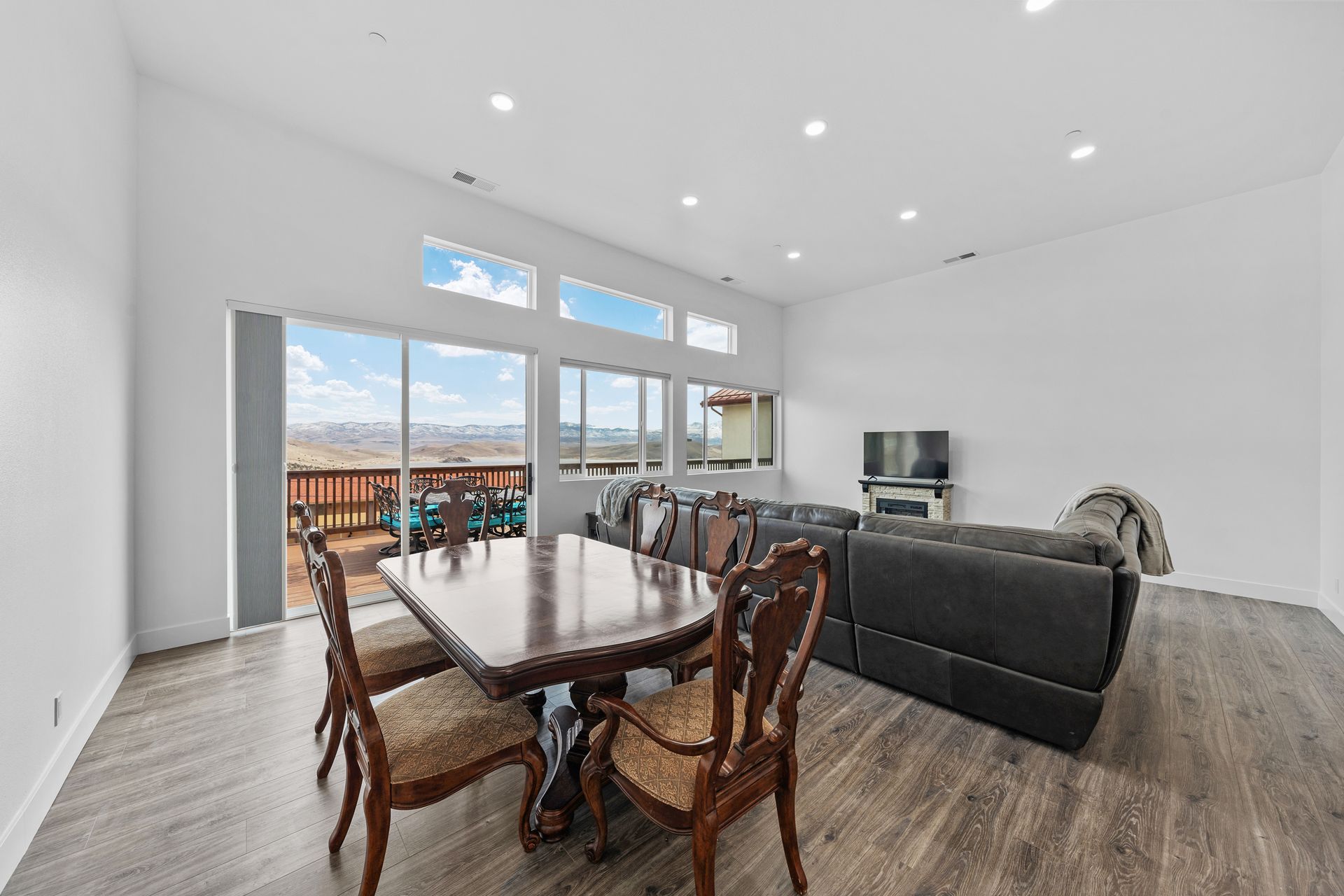 A living room with a dining table and chairs and a couch.