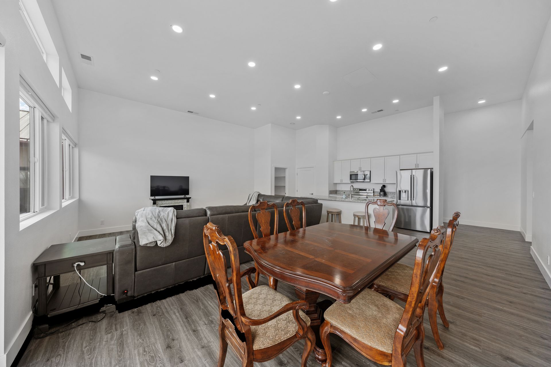 A living room with a dining table and chairs and a couch.