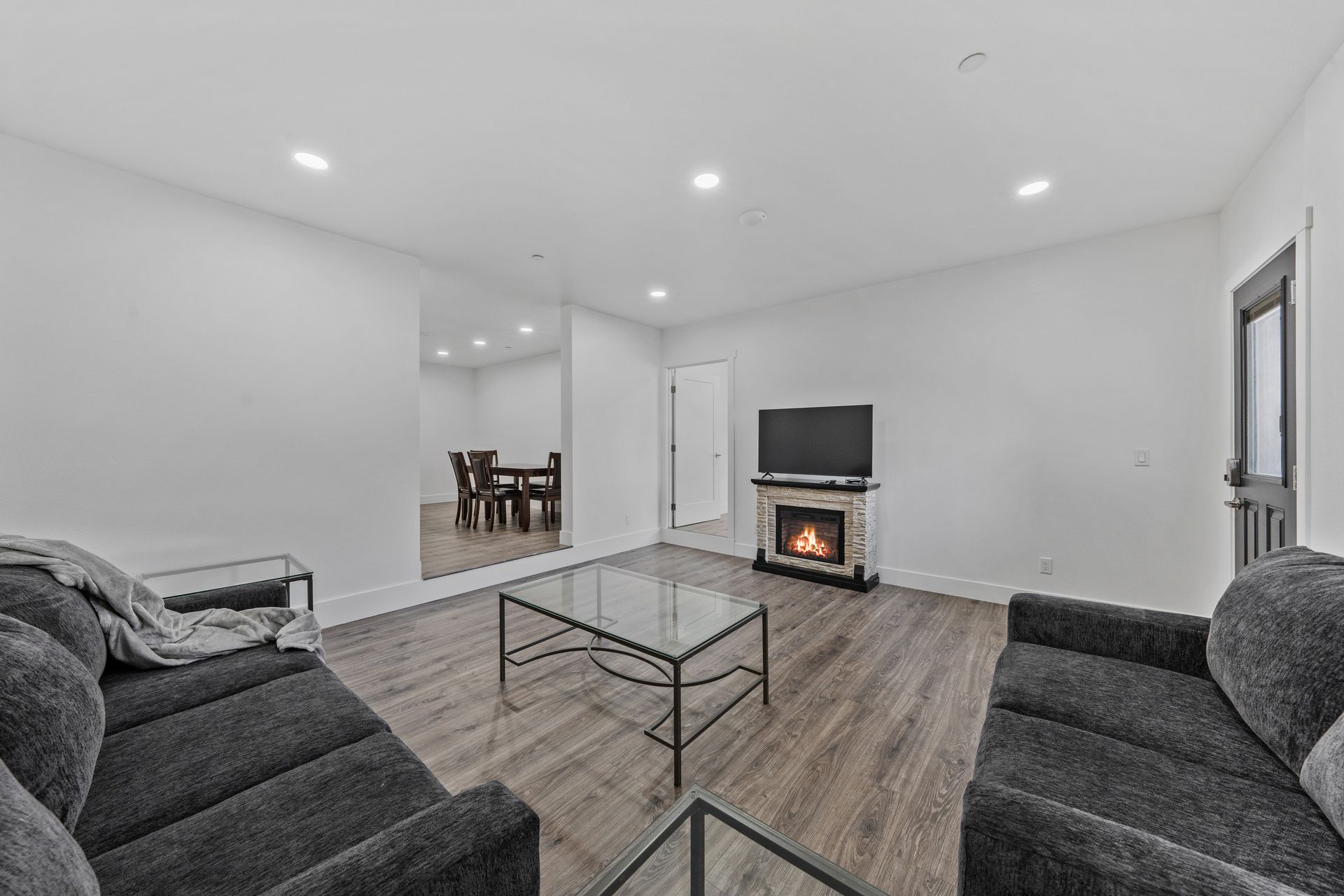 A living room with a couch , coffee table , fireplace and television.