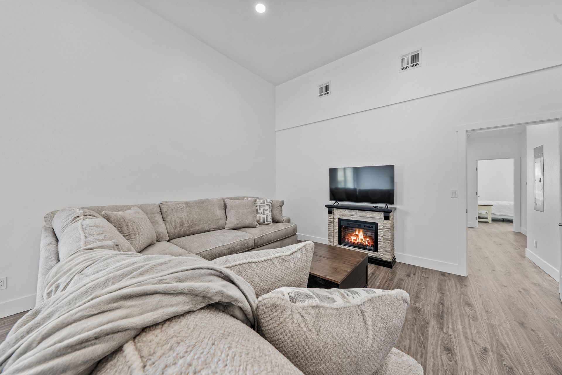 A living room with a couch , fireplace and television.