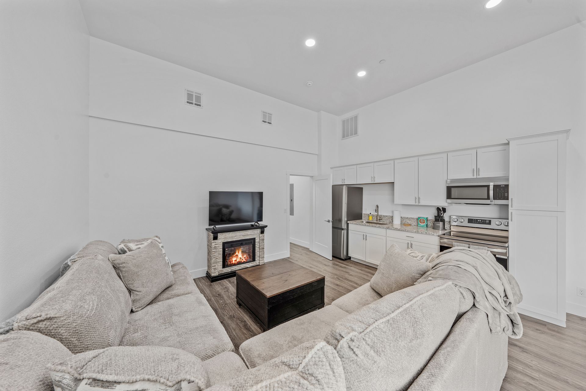 A living room with a couch , fireplace and television