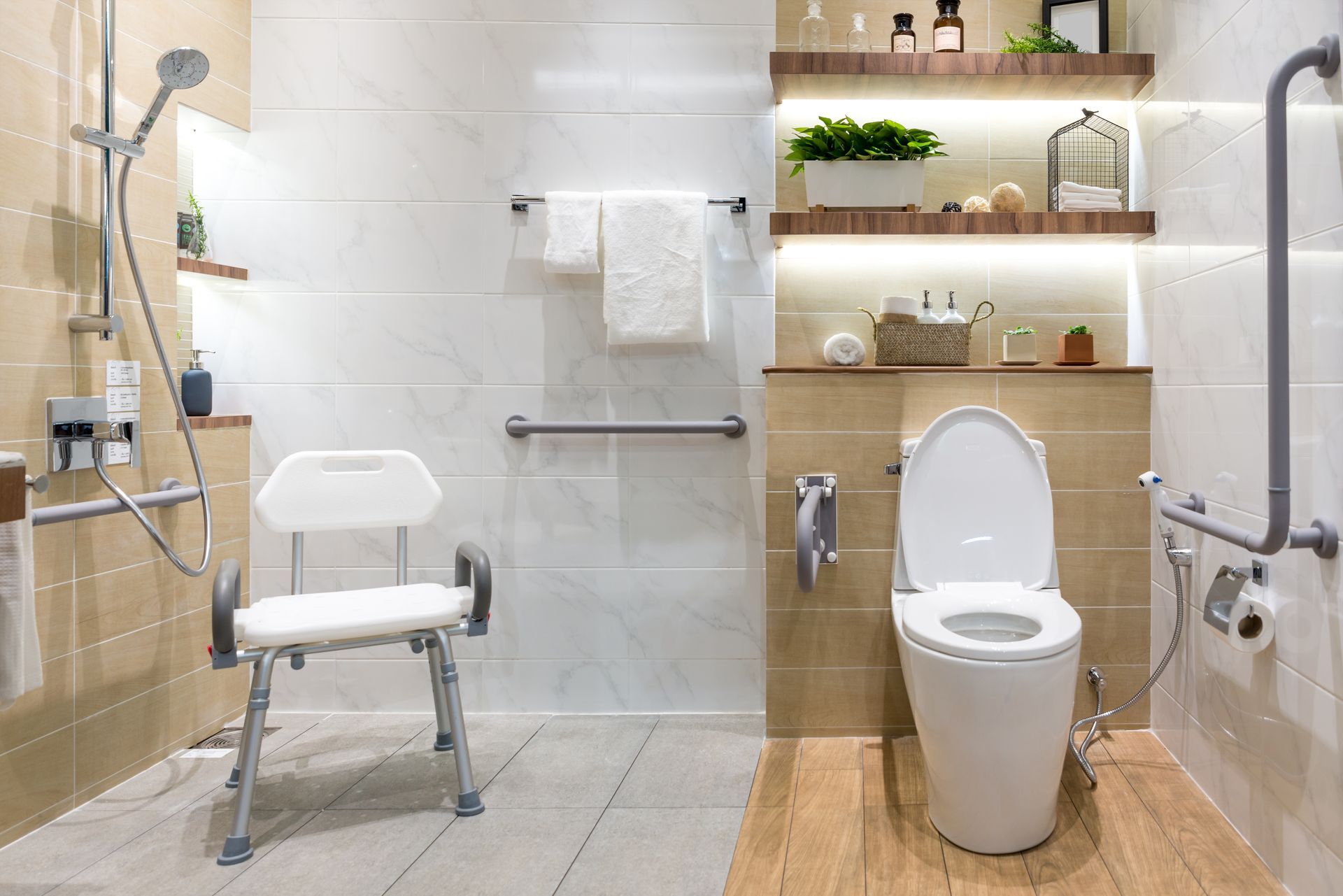 A bathroom with a toilet , shower , and chair.