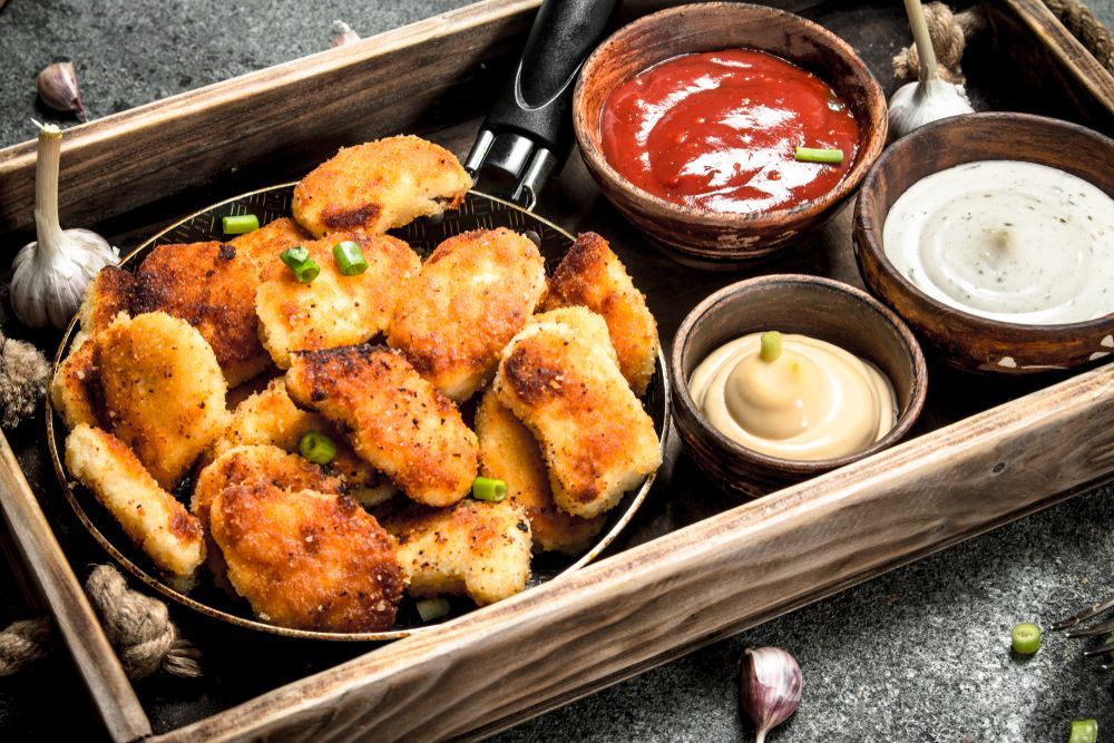 Chicken Nuggets With Ketchup, Garlic Aioli, and Mustard, in a Wooden Tray — Chefs2Go in Bowen, QLD