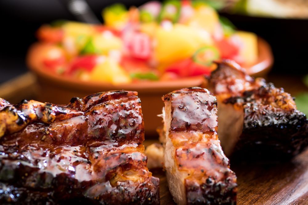Grilled Pork Belly With Pineapple Salsa on a Wooden Board — Chefs2Go in Bowen, QLD