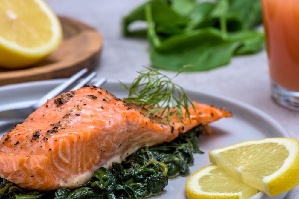 Salmon Fillet With Greens, Lemon, and a Glass of Juice — Chefs2Go in Ayr, QLD