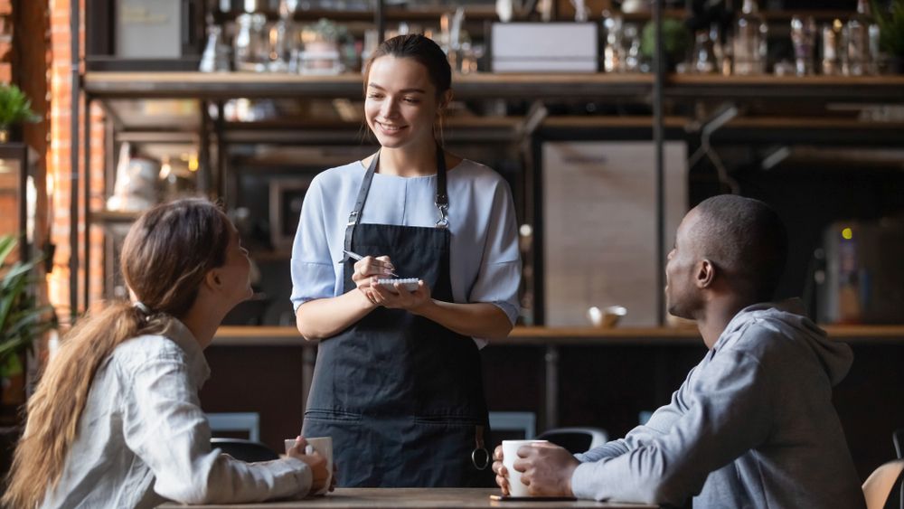 Man at a Stall Selling Drinks, Interacting With Three Customers — Chefs2Go in Woodwark, QLD
