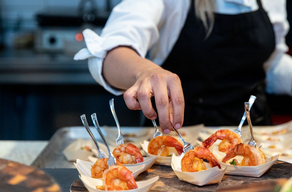 Chef Arranging Shrimp Appetizers With Skewers — Chefs2Go in Townsville, QLD