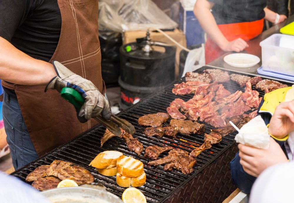 Person Grilling Various Meats and Bread on a Barbecue, Outdoors — Chefs2Go in Bowen, QLD