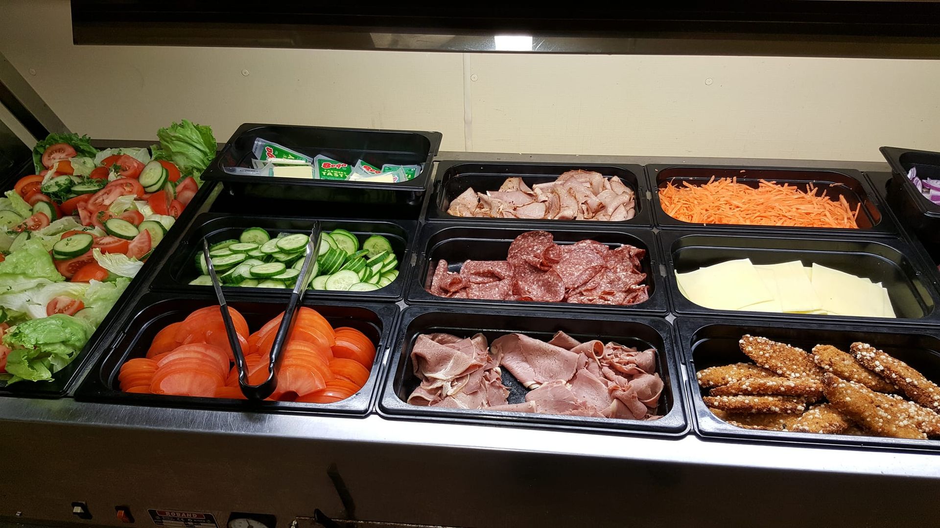 Salad Bar With Various Ingredients in Black Trays — Chefs2Go in Alice Springs, NT