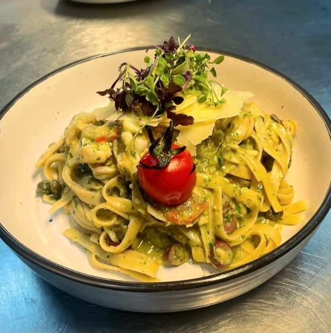 Pasta Dish With Pesto Sauce, Cherry Tomato, Microgreens, and Cheese in a White Bowl — Chefs2Go in Alice Springs, NT