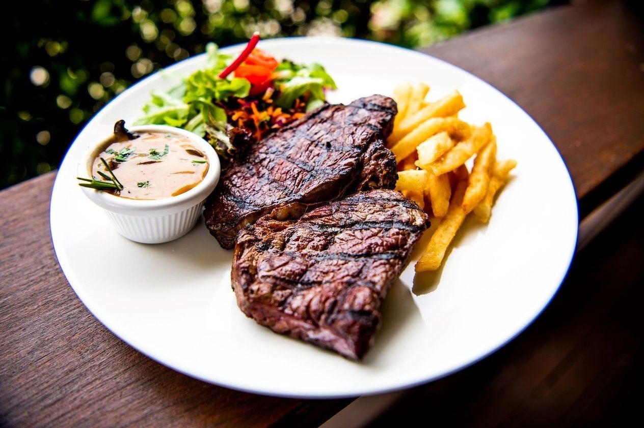 Grilled Steak, Fries, Salad, and Sauce on a White Plate, Outdoors — Chefs2Go in Gladstone, QLD