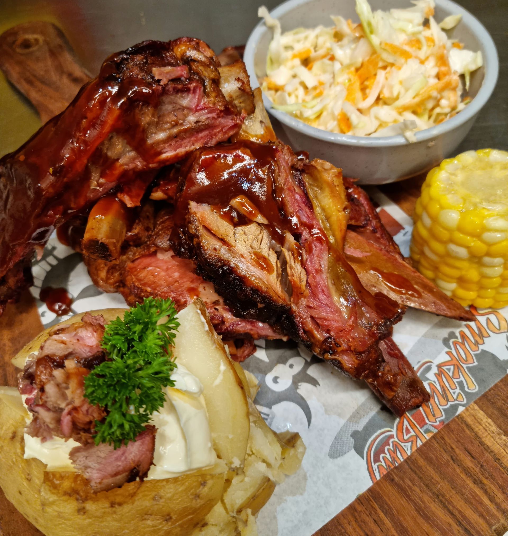 Grilled ribs with coleslaw, corn on the cob, and baked potato with toppings— Chefs2Go in Whitsunday, QLD
