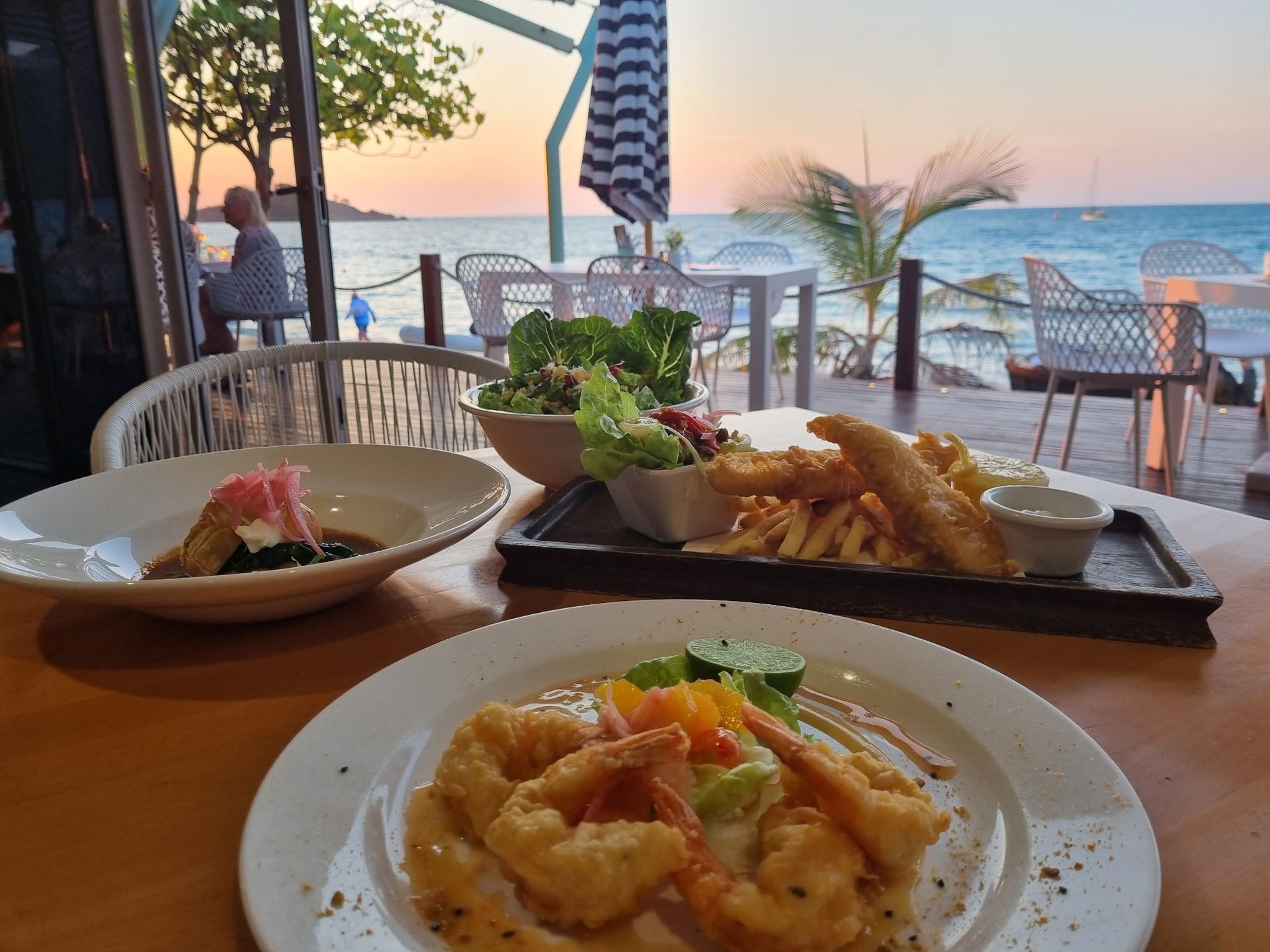 Seafood meal on a table overlooking the ocean at sunset— Chefs2Go in Whitsunday, QLD