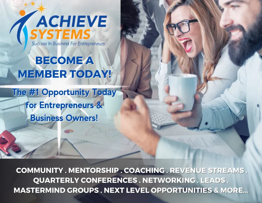 A group of people are sitting at a table looking at a laptop.