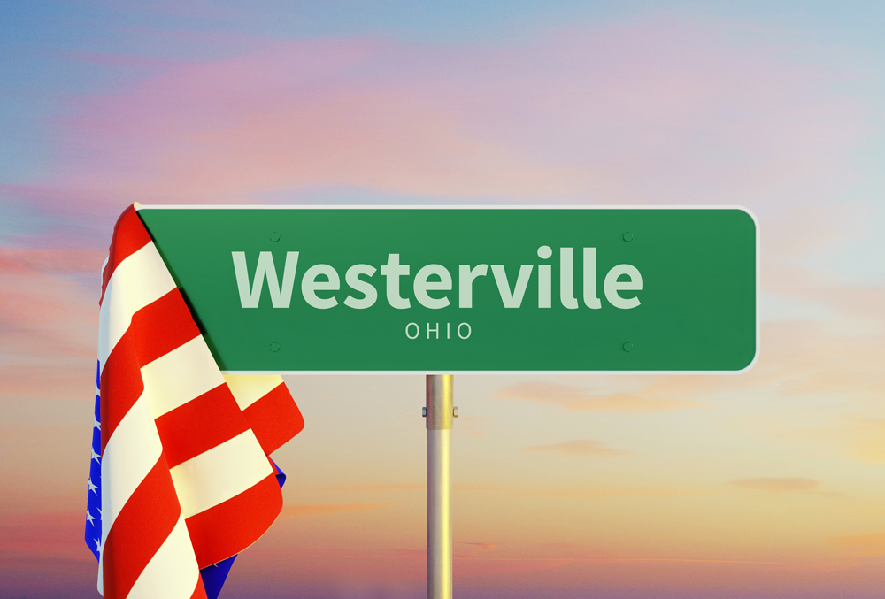 A street sign for Westerville Ohio with an American flag