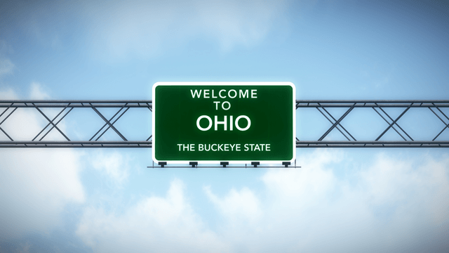 A green highway sign that says welcome to Ohio