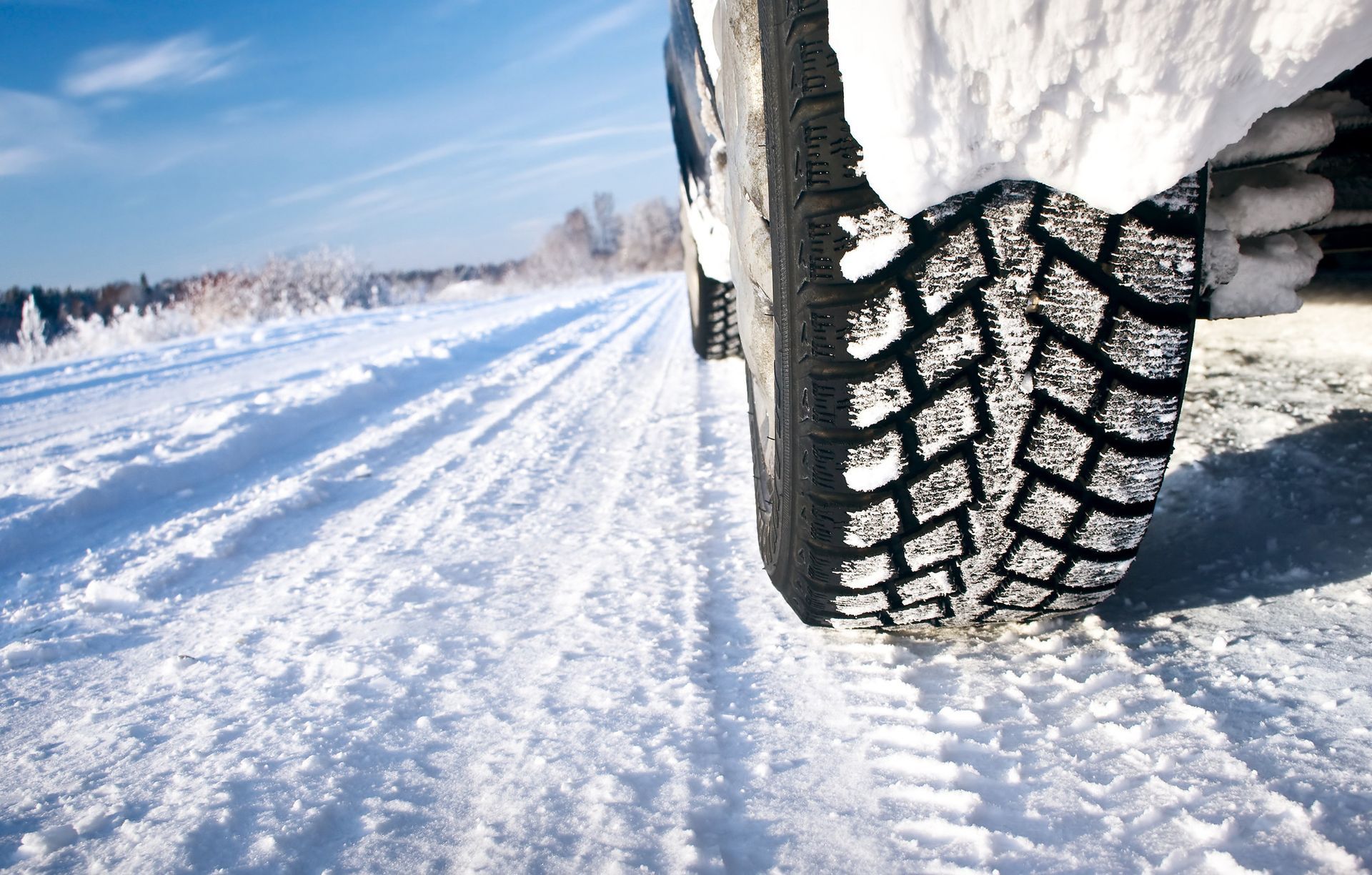 a close up of a tire on a snowy road