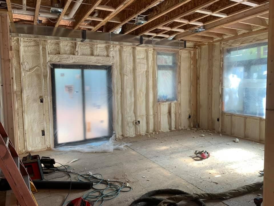 A room with a lot of insulation on the walls and a sliding glass door.