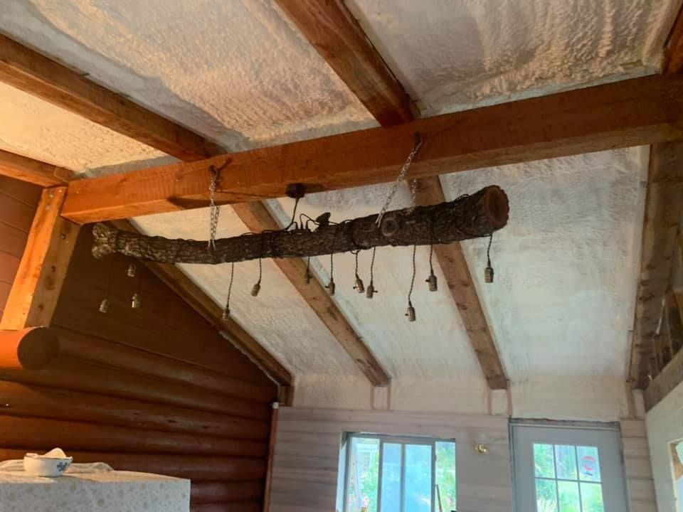 A log is hanging from the ceiling of a log cabin.