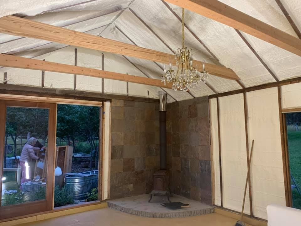 A room with a fireplace and a chandelier hanging from the ceiling.