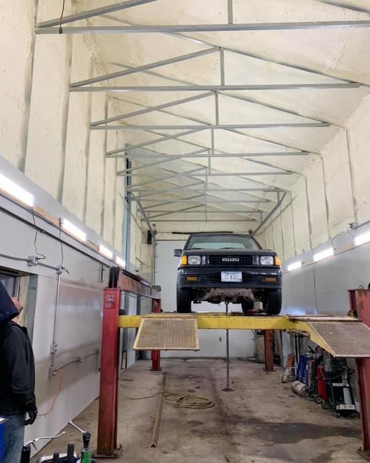 A car is sitting on a lift in a garage