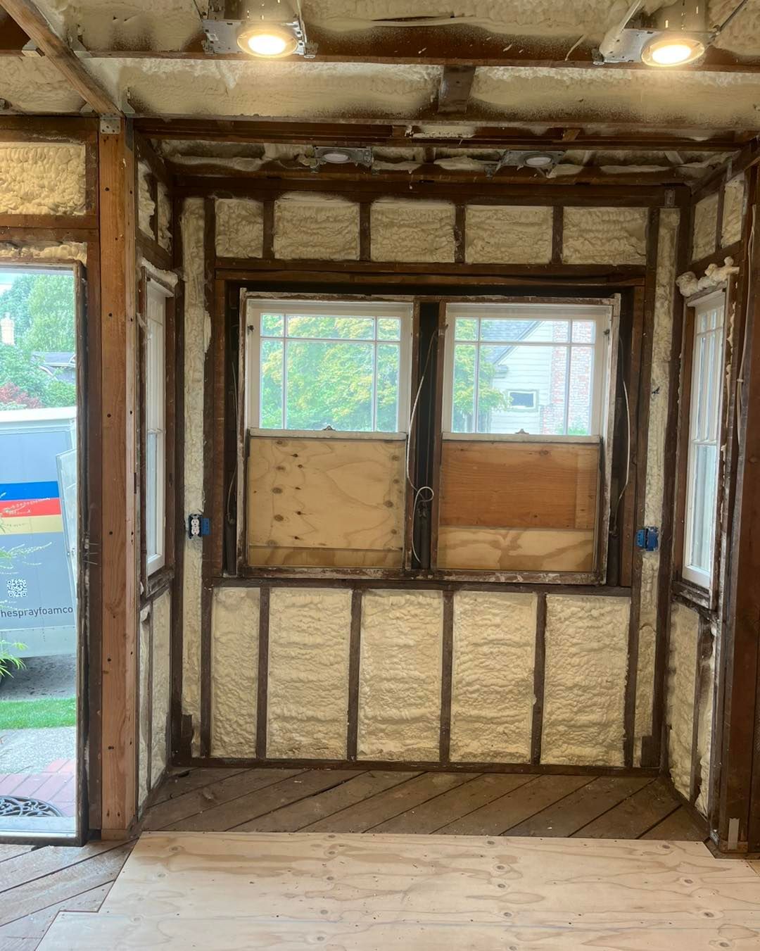 A room with foam insulation on the walls and a window.